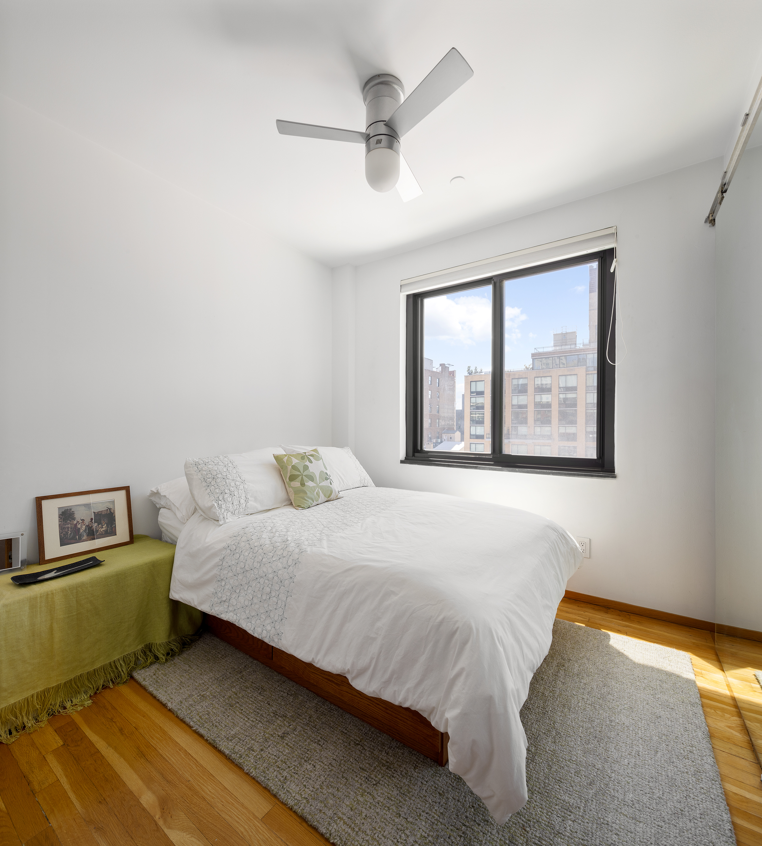 181 7th Avenue, Unit 11A Manhattan, NY 10011 - Photo 9 of 13 a bedroom with a bed and a large window