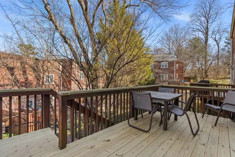 a view of balcony with chairs and wooden fence