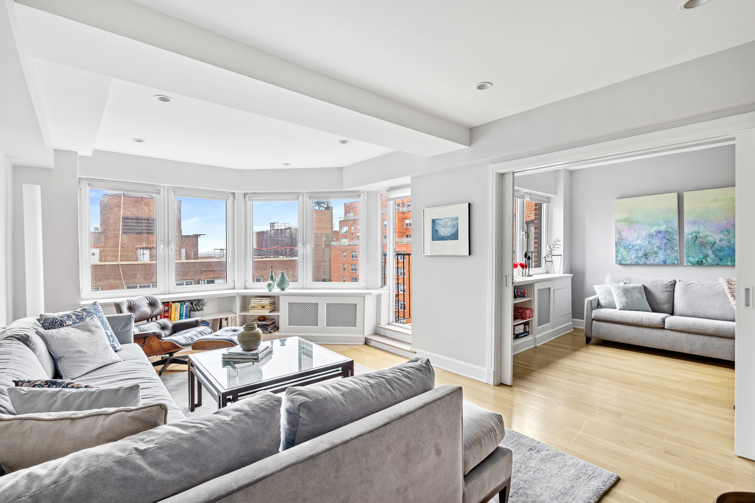 80 East End Avenue, Unit 17C Manhattan, NY 10028 - Photo 1 of 11 a living room with furniture and large windows