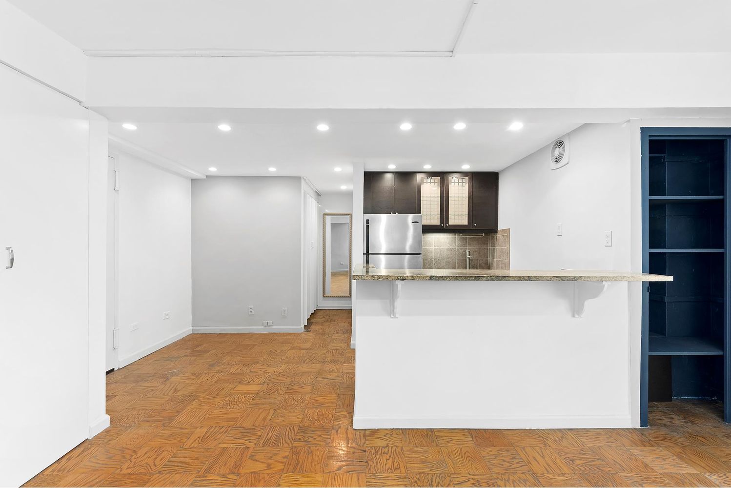 40 Sutton Place, Unit 8D Manhattan, NY 10022 - Photo 3 of 12 a view of kitchen with refrigerator and wooden floor
