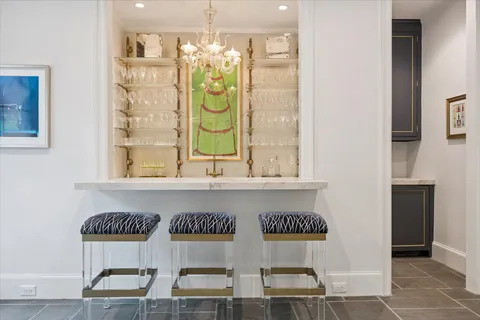 a living room with furniture floor to ceiling window hardwood floor and a flat screen tv