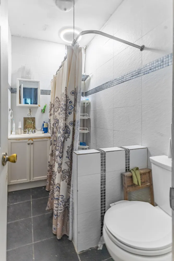 a white toilet sitting next to a bathroom sink