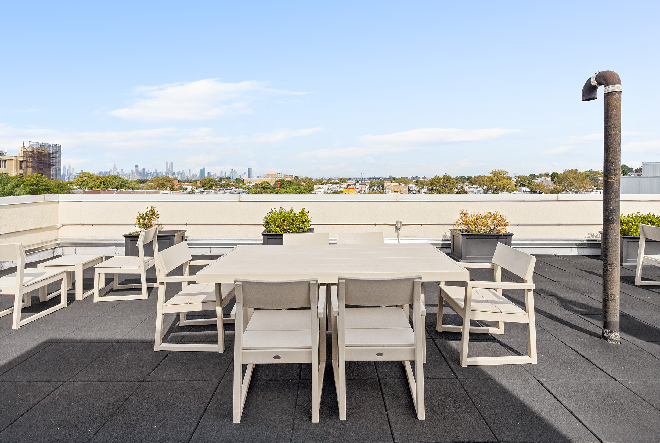 63-34 Fresh Pond Road, Unit 3D Queens, NY 11385 - Photo 8 of 14 a dining table and chairs with the ocean view