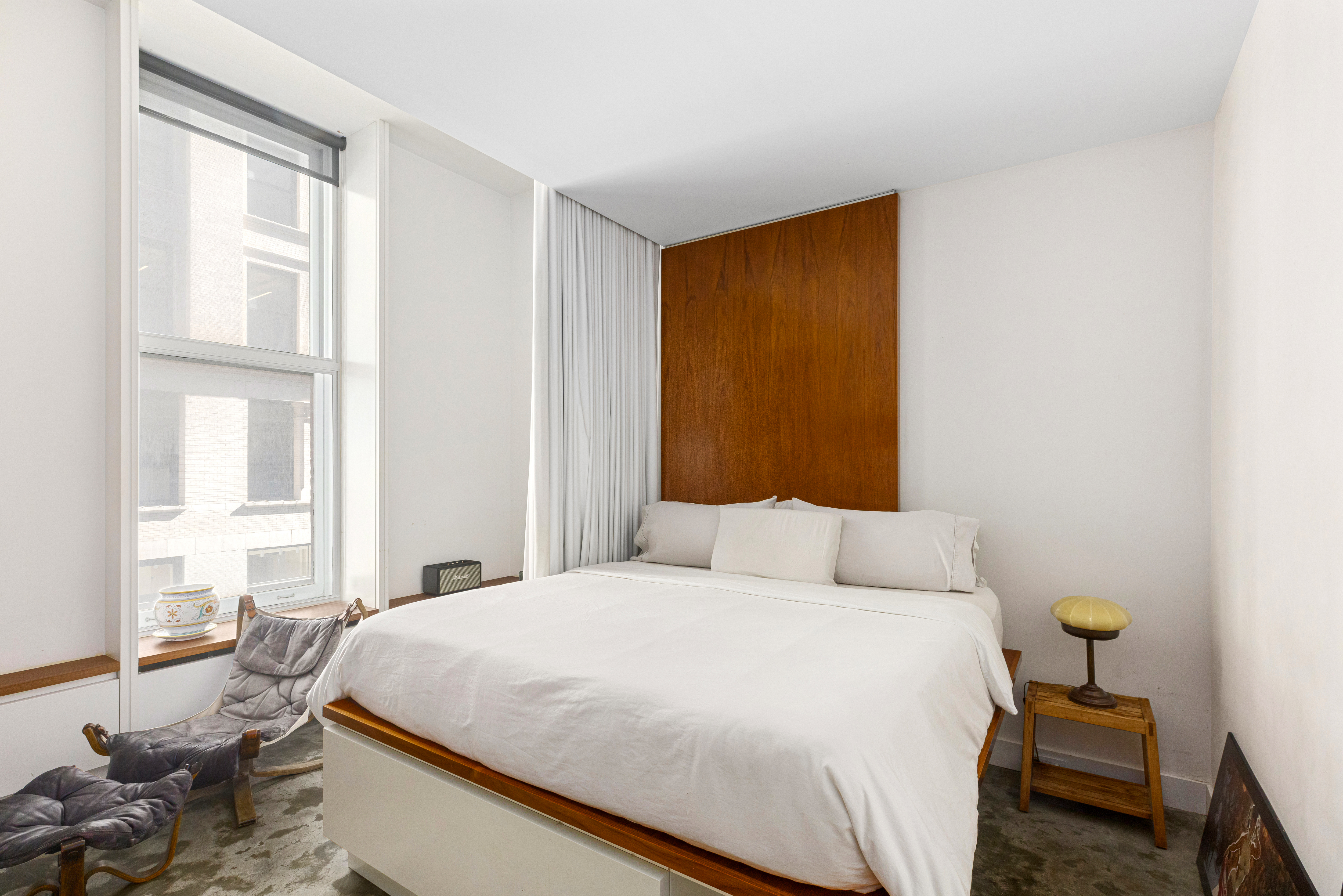 76 Crosby Street, Unit 2B Manhattan, NY 10012 - Photo 6 of 17 a bedroom with a bed and wooden floor