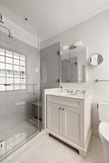 a bathroom with a sink toilet and shower