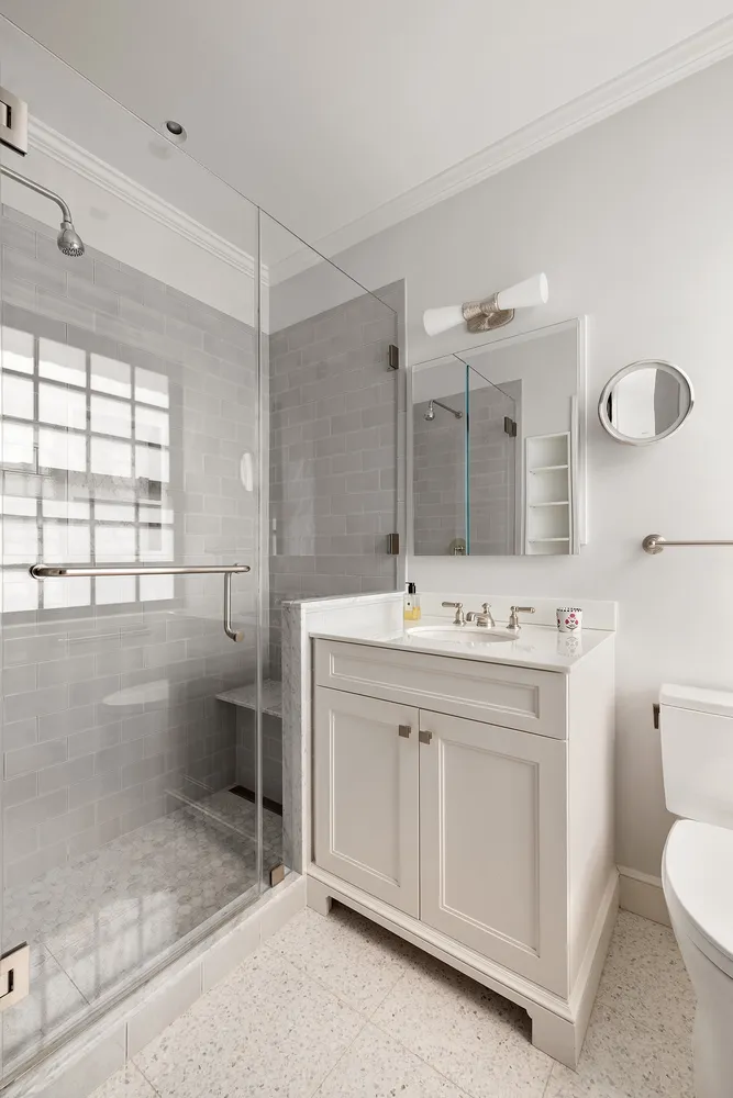 a bathroom with a sink toilet and shower