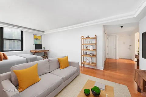 a living room with furniture and painting on the wall