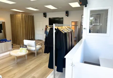 a living room with furniture a flat screen tv and a table