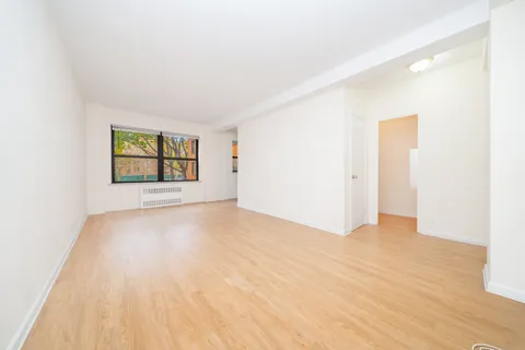 an empty room with windows and closet