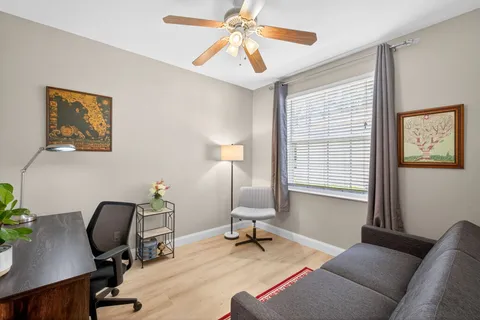 a view of a livingroom with workspace and a window