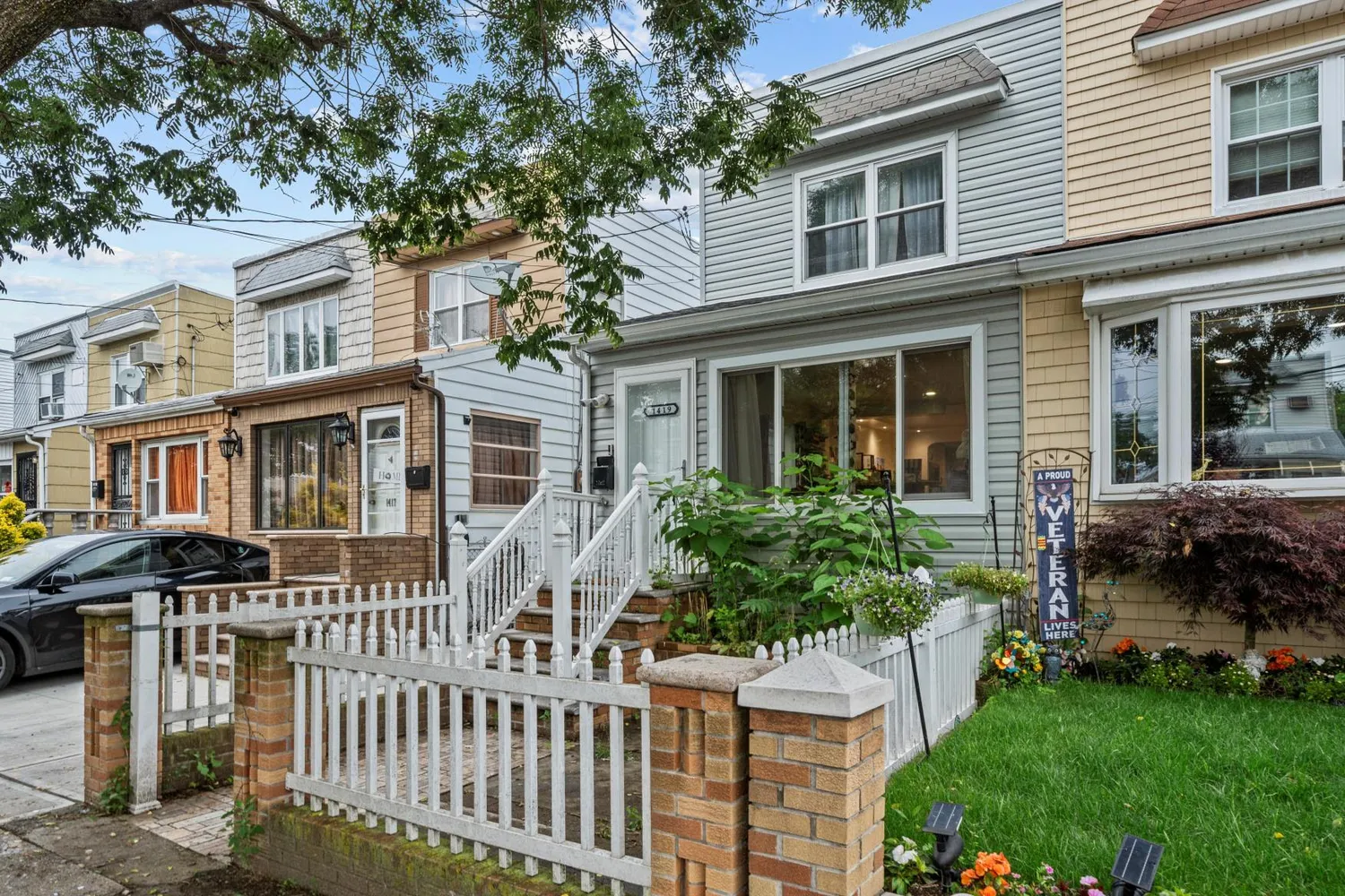 a front view of a house with a garden
