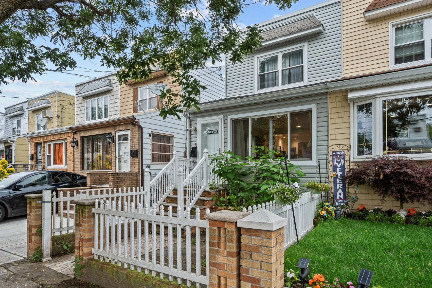 1419 East 54th Street Brooklyn, NY 11234 - Photo 4 of 19 a front view of a house with a garden