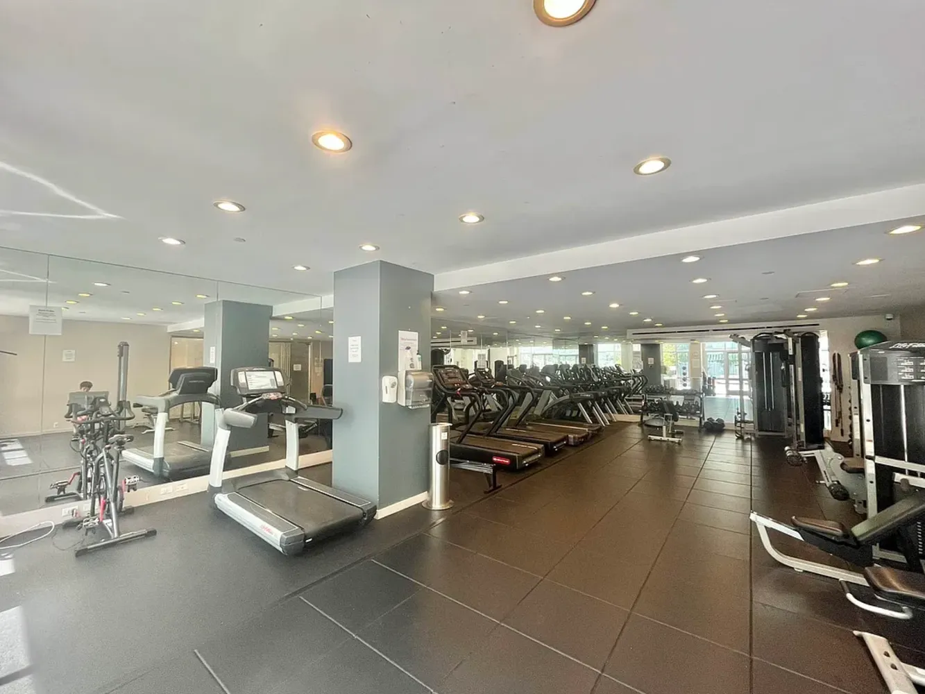 a view of a room with gym equipment and couch