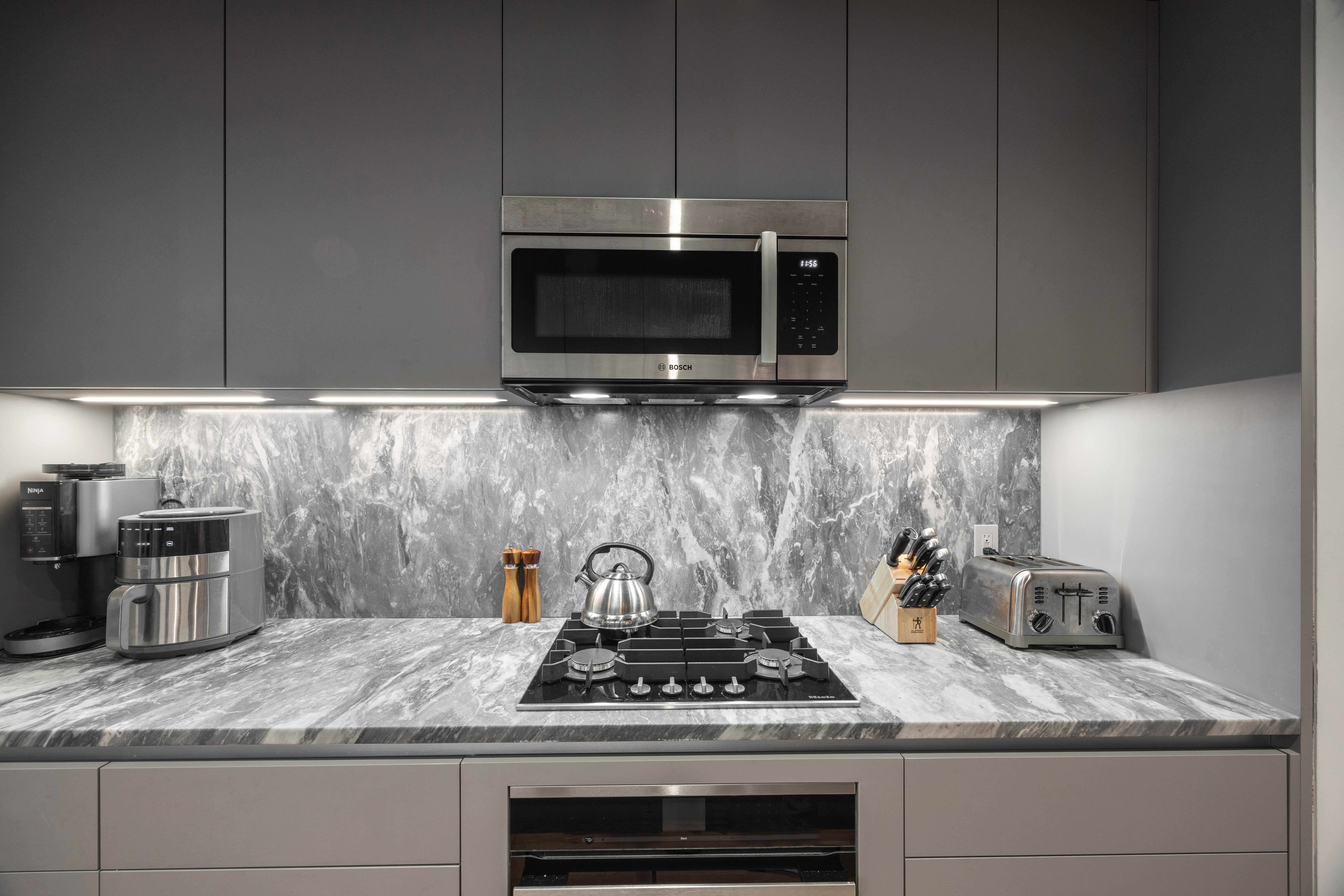 547 West 47th Street, Unit 509 Manhattan, NY 10036 - Photo 8 of 29 a kitchen with granite countertop a stove and a sink