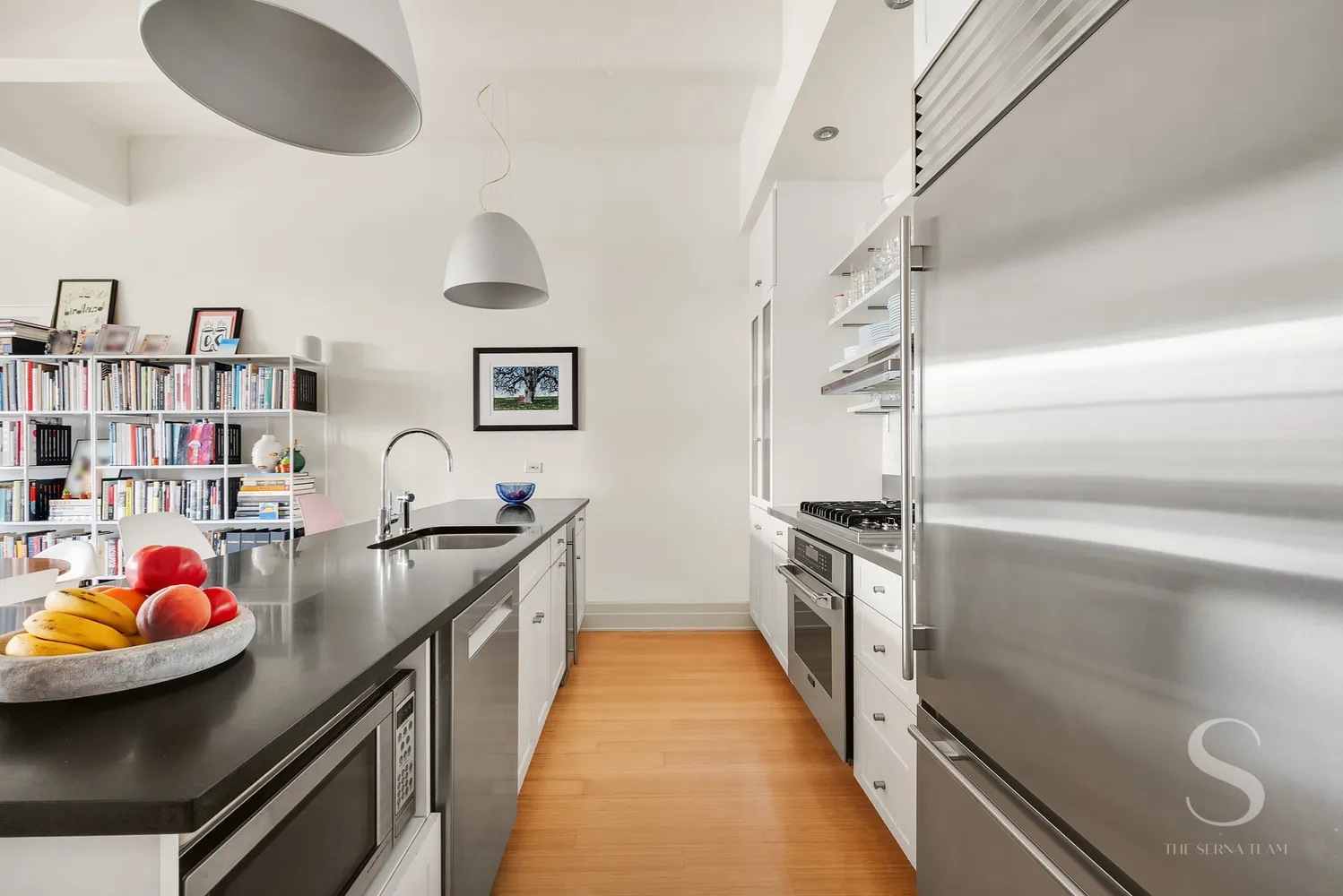 a kitchen with stainless steel appliances granite countertop a stove and cabinets