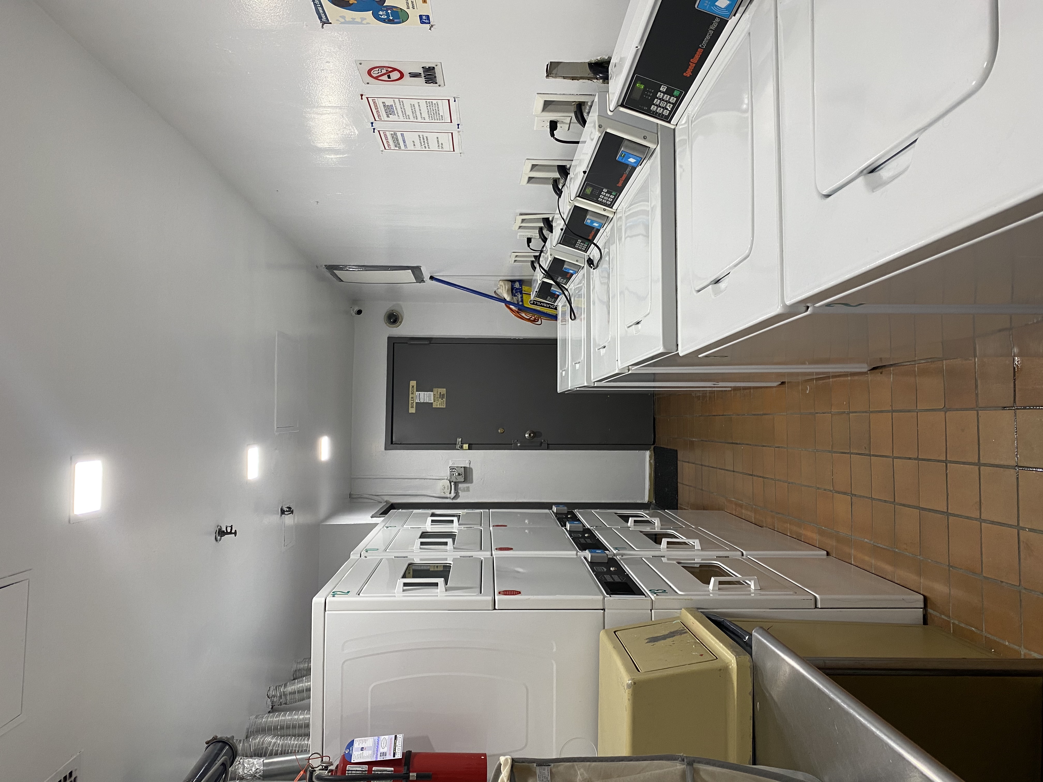 231 East 13th Street, Unit 6E Manhattan, NY 10003 - Photo 5 of 9 a view of a kitchen with kitchen island a sink a stove and a refrigerator