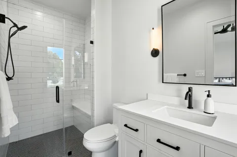 an aerial view of residential houses with outdoor space and trees all around