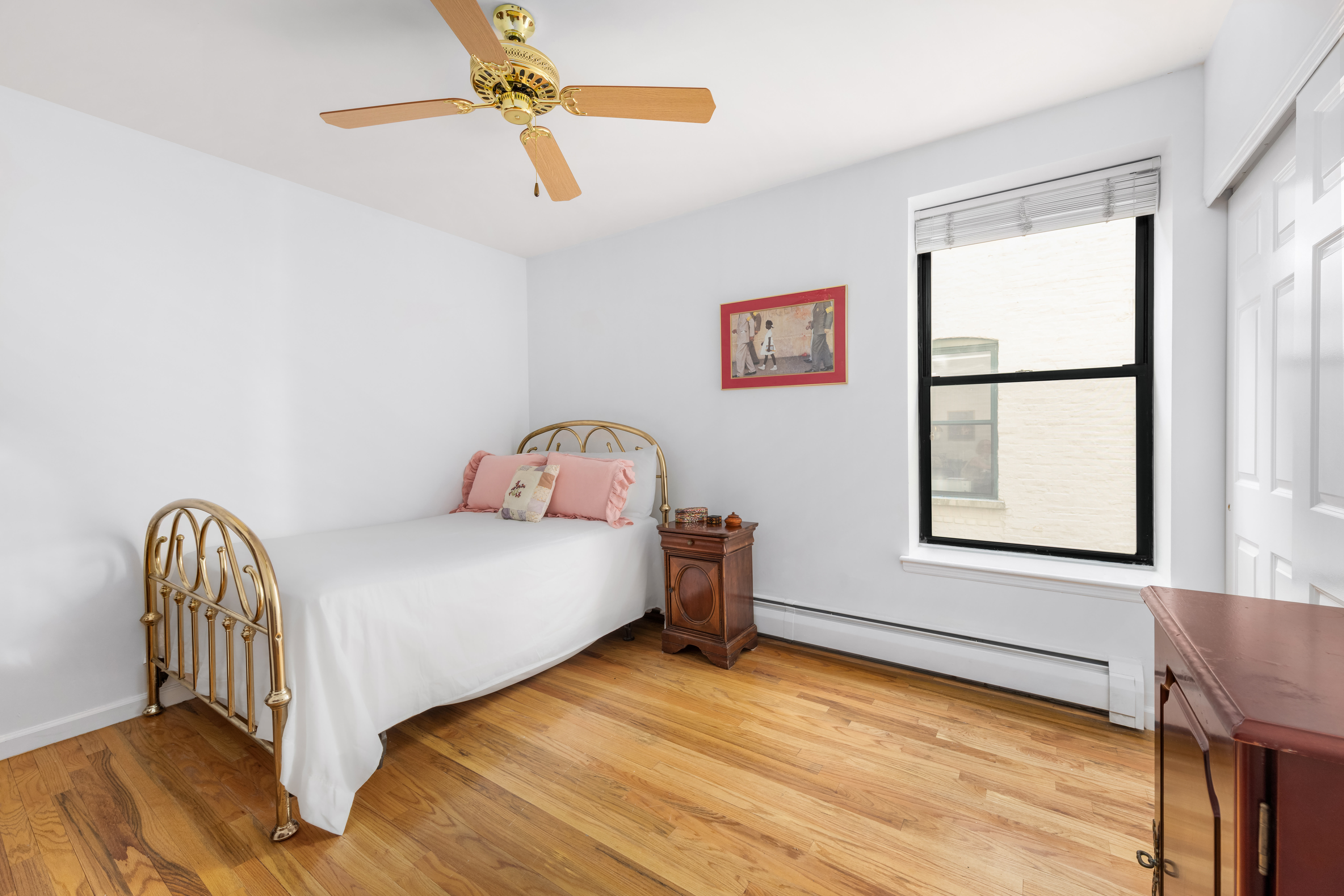 231 West 148th Street, Unit 2L Manhattan, NY 10039 - Photo 8 of 15 a bedroom with a bed and a window