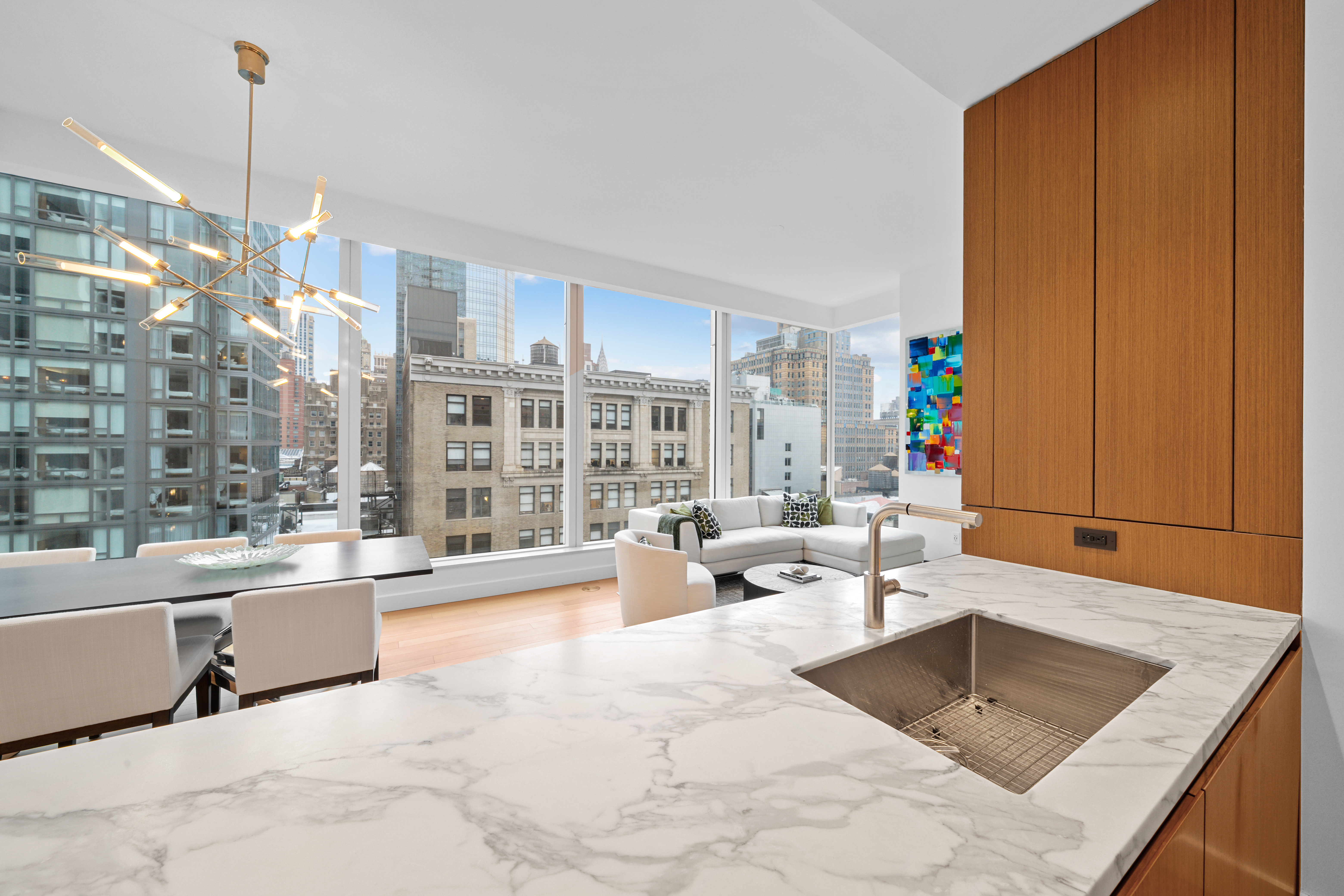 15 East 30th Street, Unit 19B Manhattan, NY 10016 - Photo 13 of 40 a living room filled with furniture and a chandelier