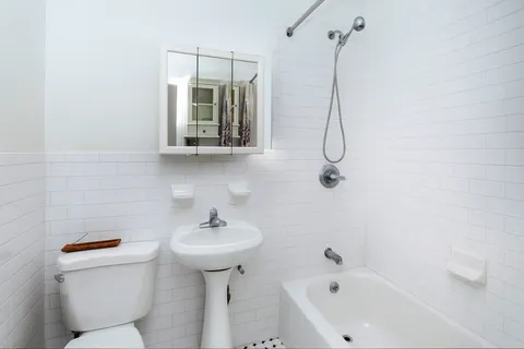 a bathroom with a sink a toilet and a bathtub