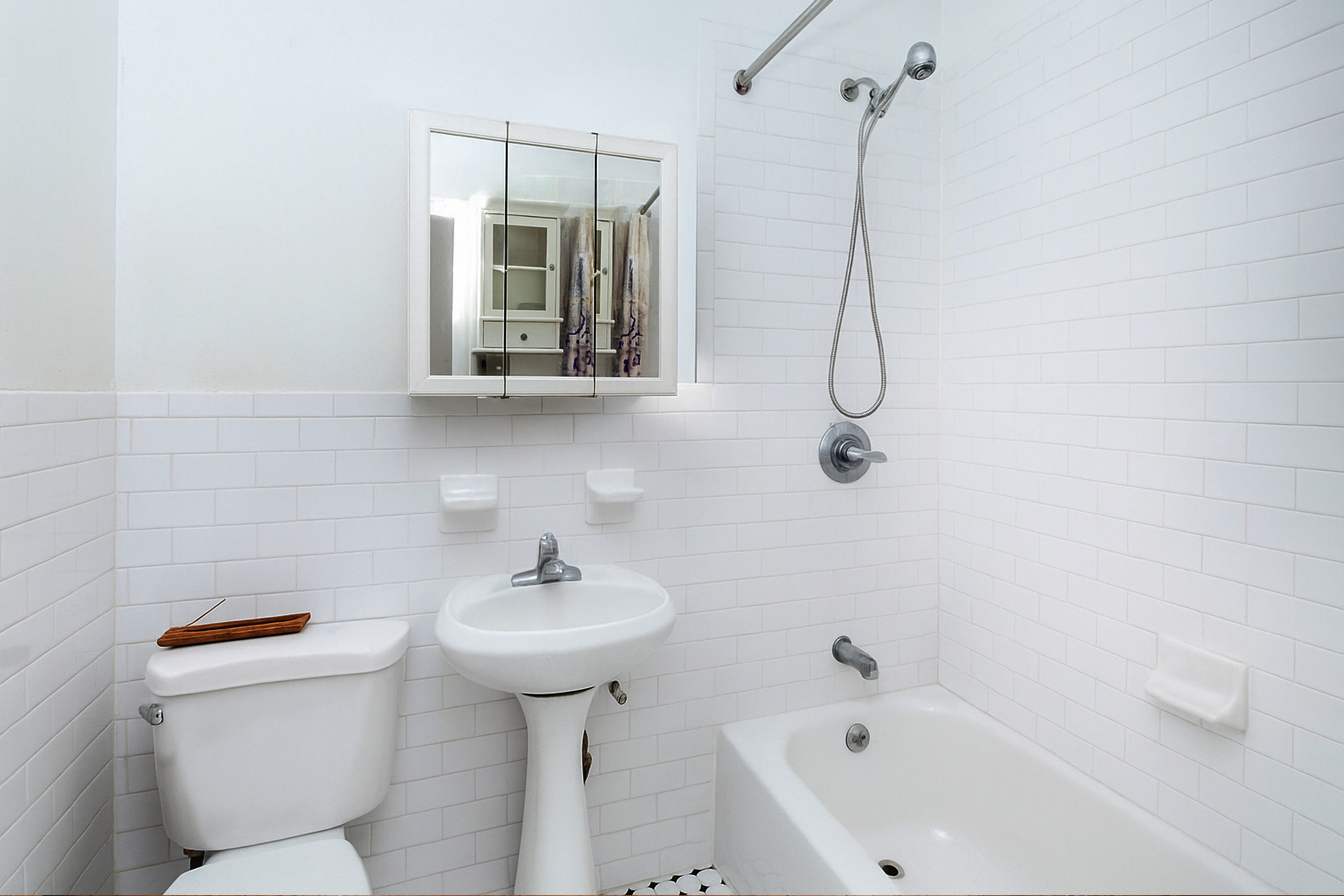 73 Monroe Street Brooklyn, NY 11216 - Photo 10 of 14 a bathroom with a sink a toilet and a bathtub