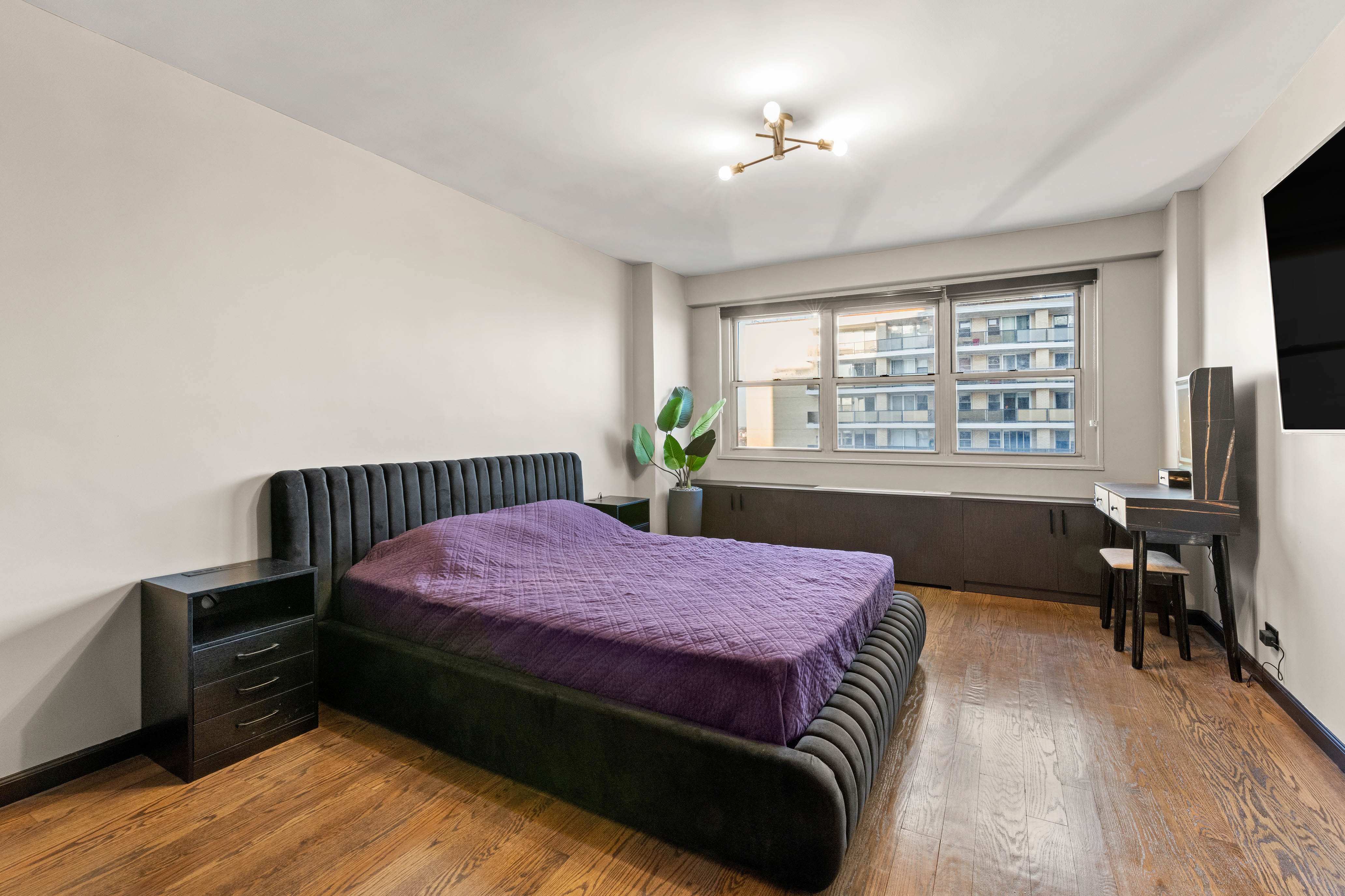 102-10 66th Road, Unit K25 Queens, NY 11375 - Photo 10 of 19 a bedroom with a bed and wooden floor