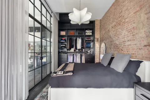 a living room with furniture a chandelier and a book shelf