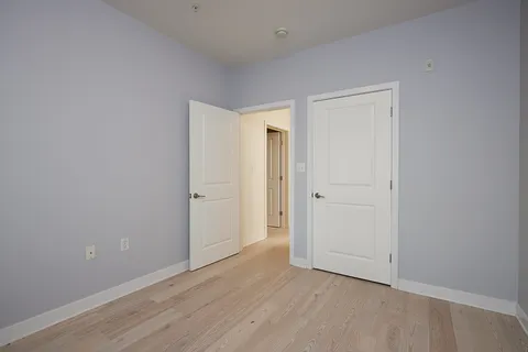 a view of an empty room and wooden floor