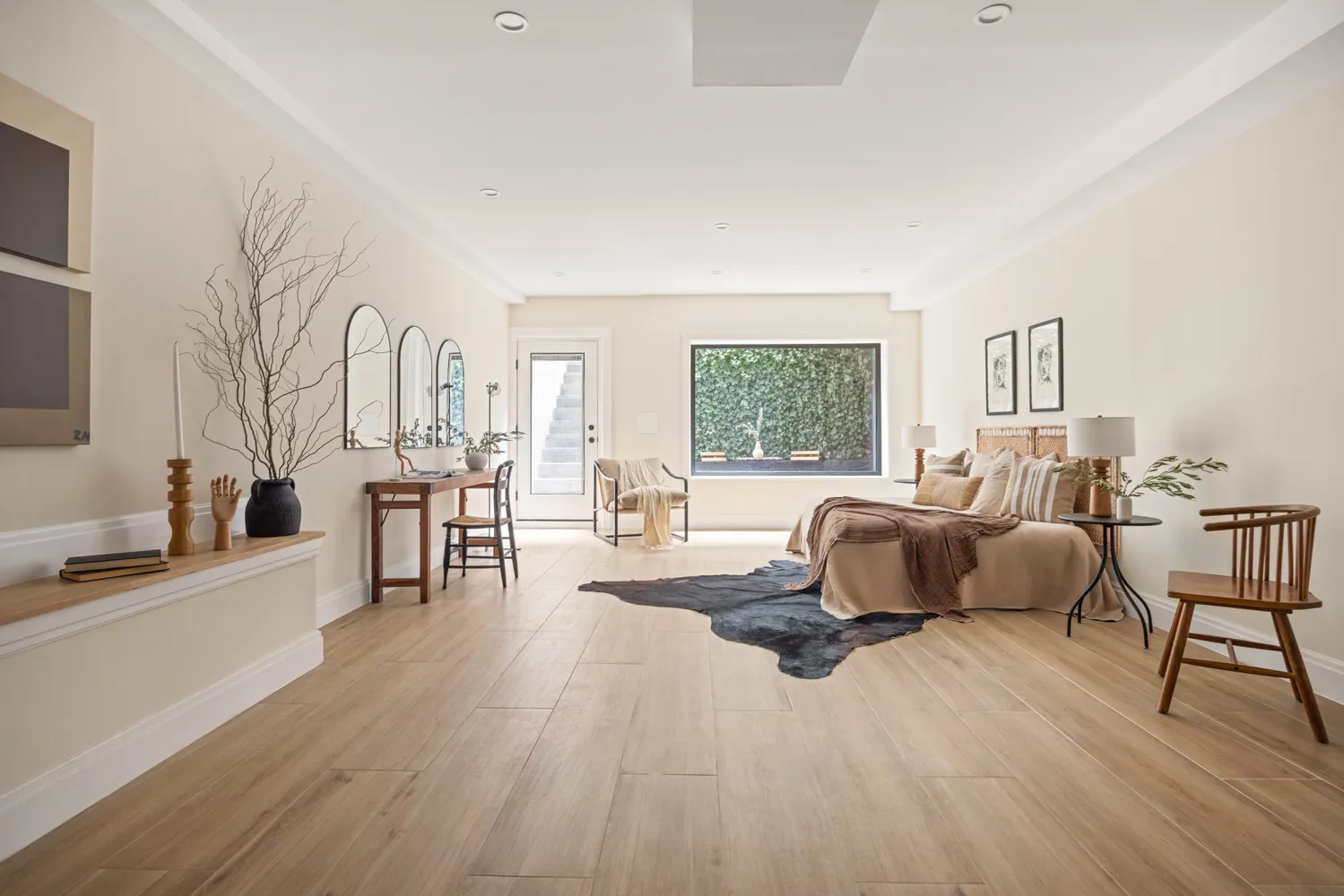 a bedroom with furniture and a wooden floor