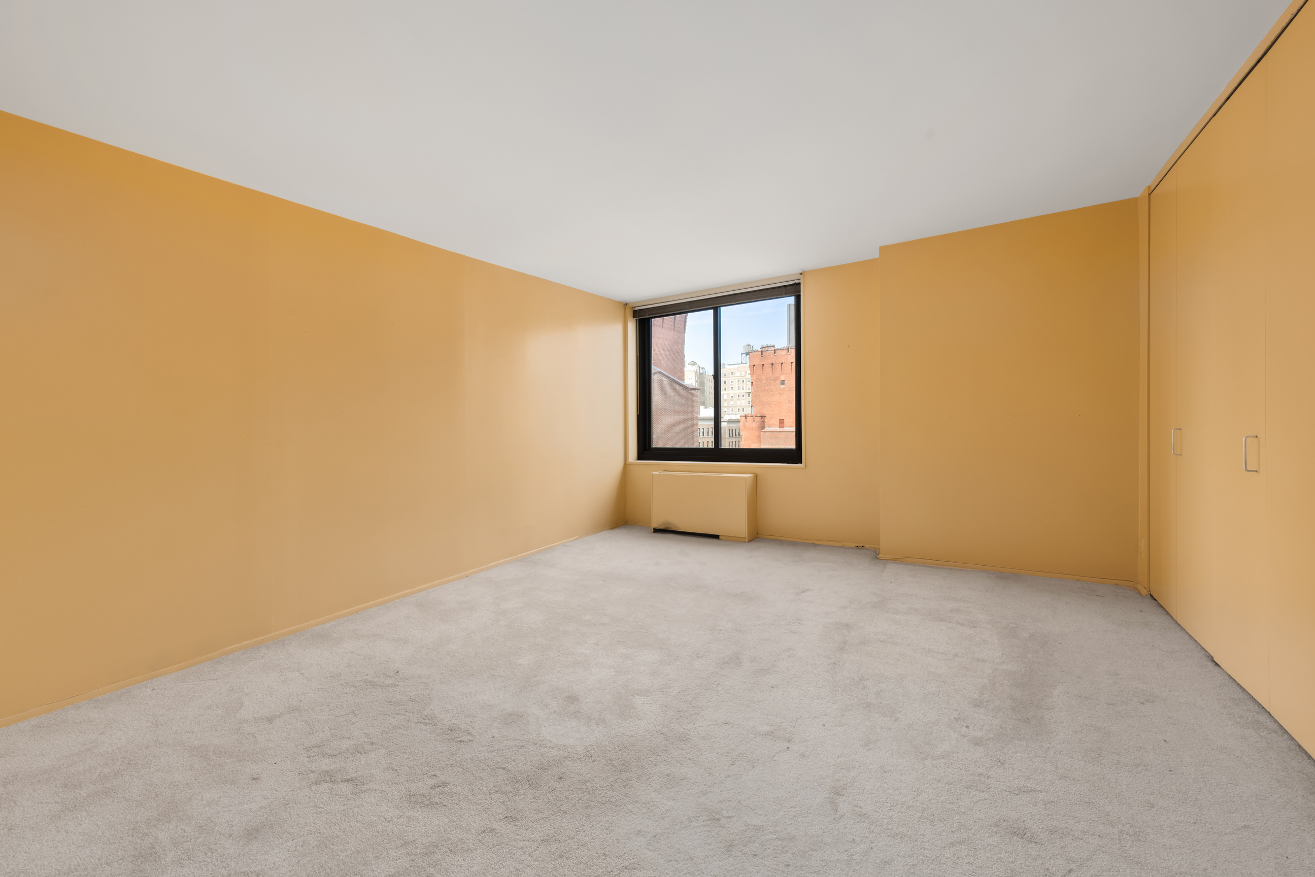 40 East 94th Street, Unit 6F Manhattan, NY 10128 - Photo 4 of 17 an empty room with windows