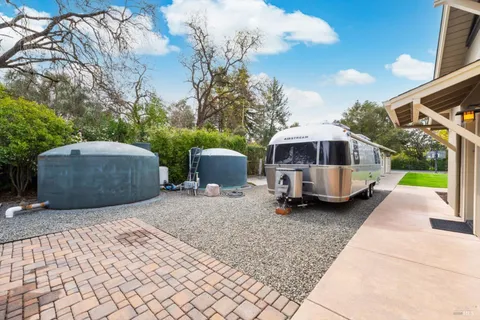 a view of a kitchen with a stove and wooden cabinets