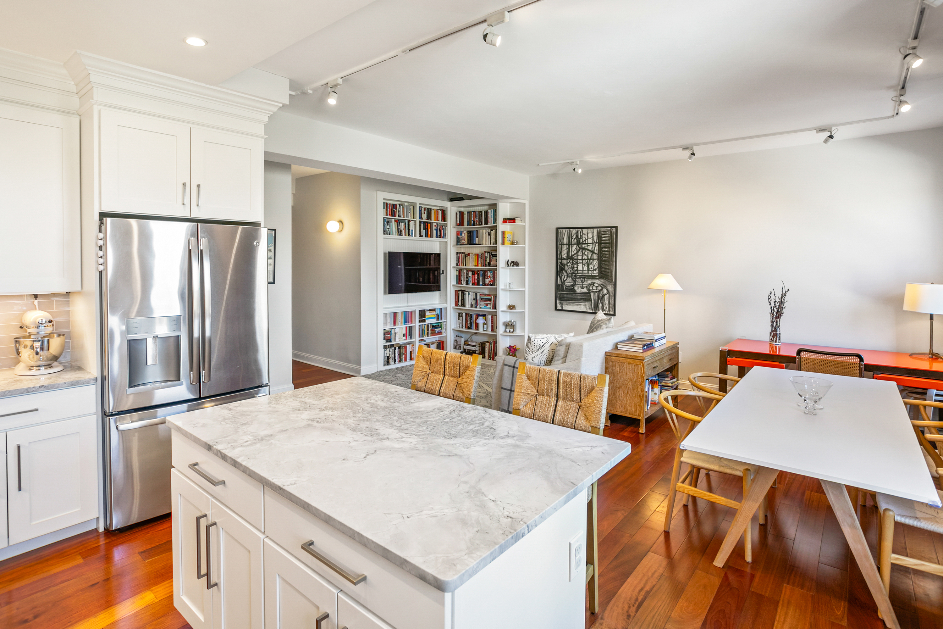 2123 California Street Northwest, Unit D5 Washington, DC 20008 - Photo 8 of 25 a kitchen with stainless steel appliances granite countertop a table chairs and a refrigerator