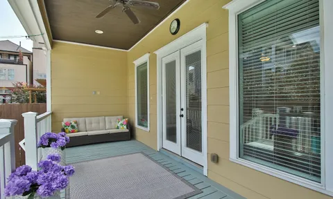a backyard with a table and chairs and potted plants