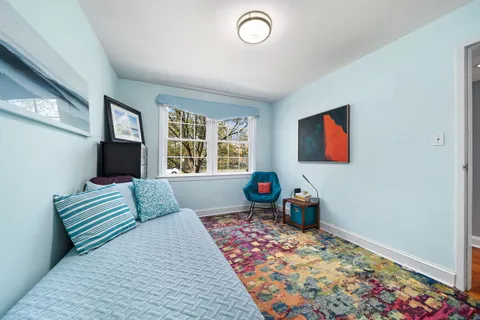 a bedroom with furniture and a window