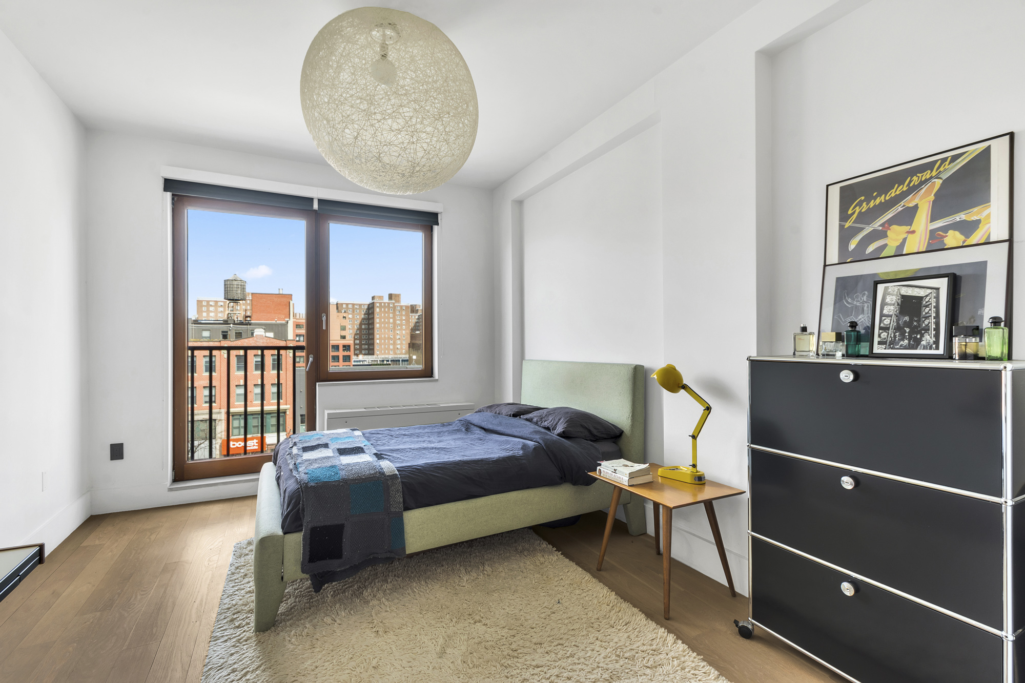 267 West 124th Street, Unit 6A Manhattan, NY 10027 - Photo 17 of 24 a bedroom with a bed and a chandelier