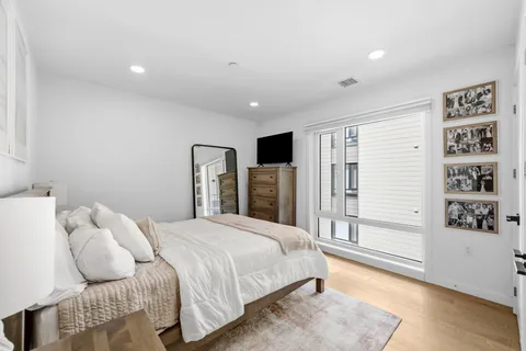 a bedroom with a large bed and a window