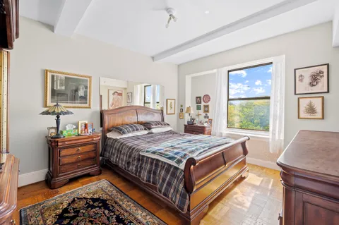 a bedroom with a bed and window
