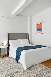 a bedroom with a bed and lamp