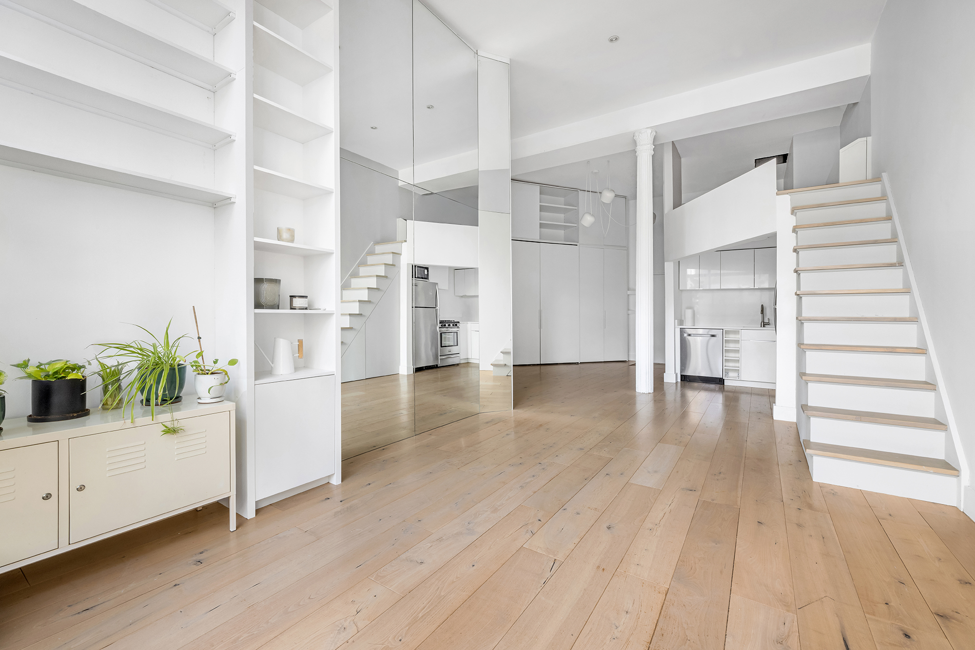 77 Bleecker Street, Unit 617 Manhattan, NY 10012 - Photo 6 of 13 a view of a kitchen and entryway with wooden floor