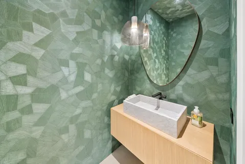 a bathroom with a sink toilet and mirror