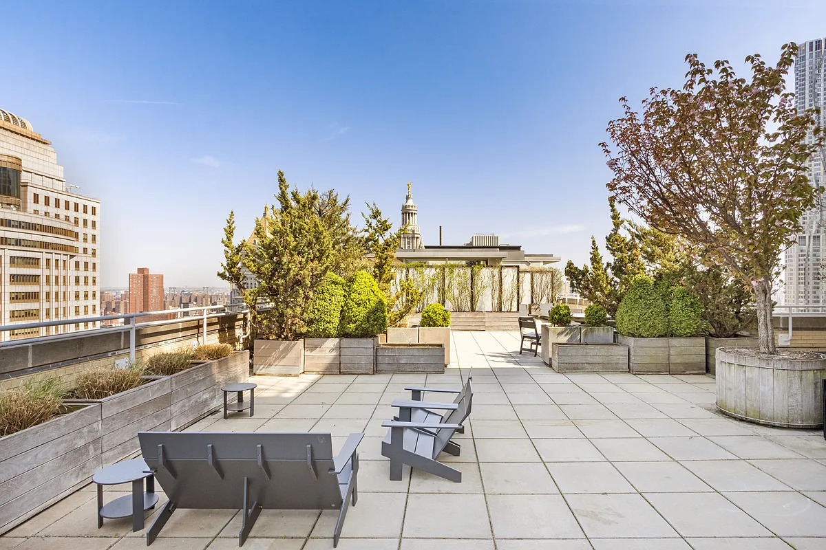 80 Chambers Street, Unit 12C Manhattan, NY 10007 - Photo 9 of 15 a view of a patio with dining table and chairs