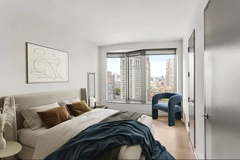 a bedroom with furniture and a large window