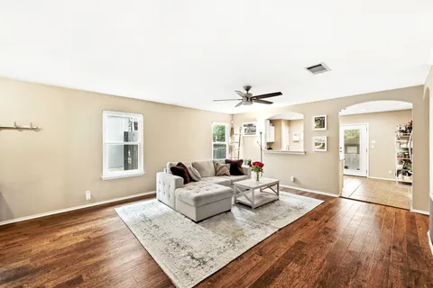 a living room with furniture and wooden floor