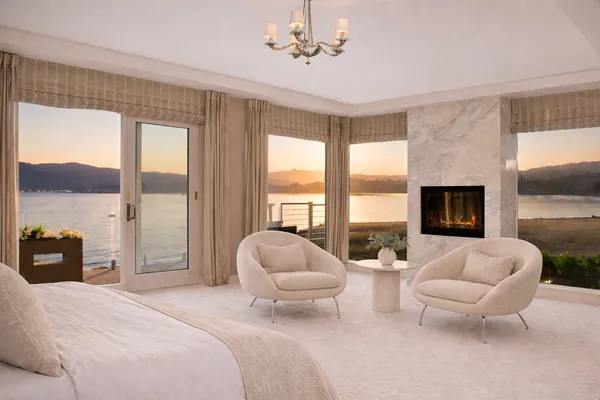 a spacious bedroom with two beds and a large window