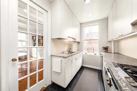 a kitchen with stainless steel appliances granite countertop a stove and a sink
