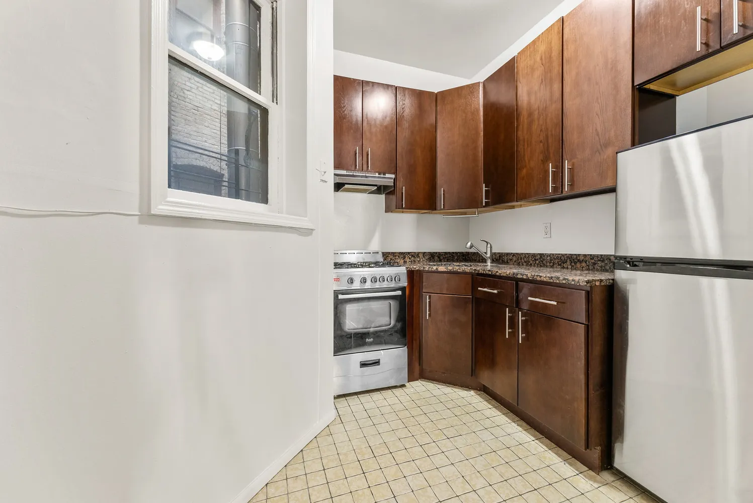 a kitchen with a sink a stove and cabinets