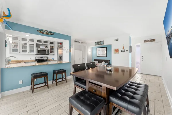 a living room with furniture a dining table and a large window