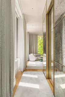 a bedroom with a bed and glass door