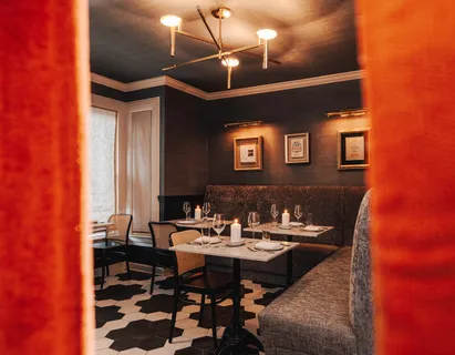 a view of a dining room with furniture and chandelier