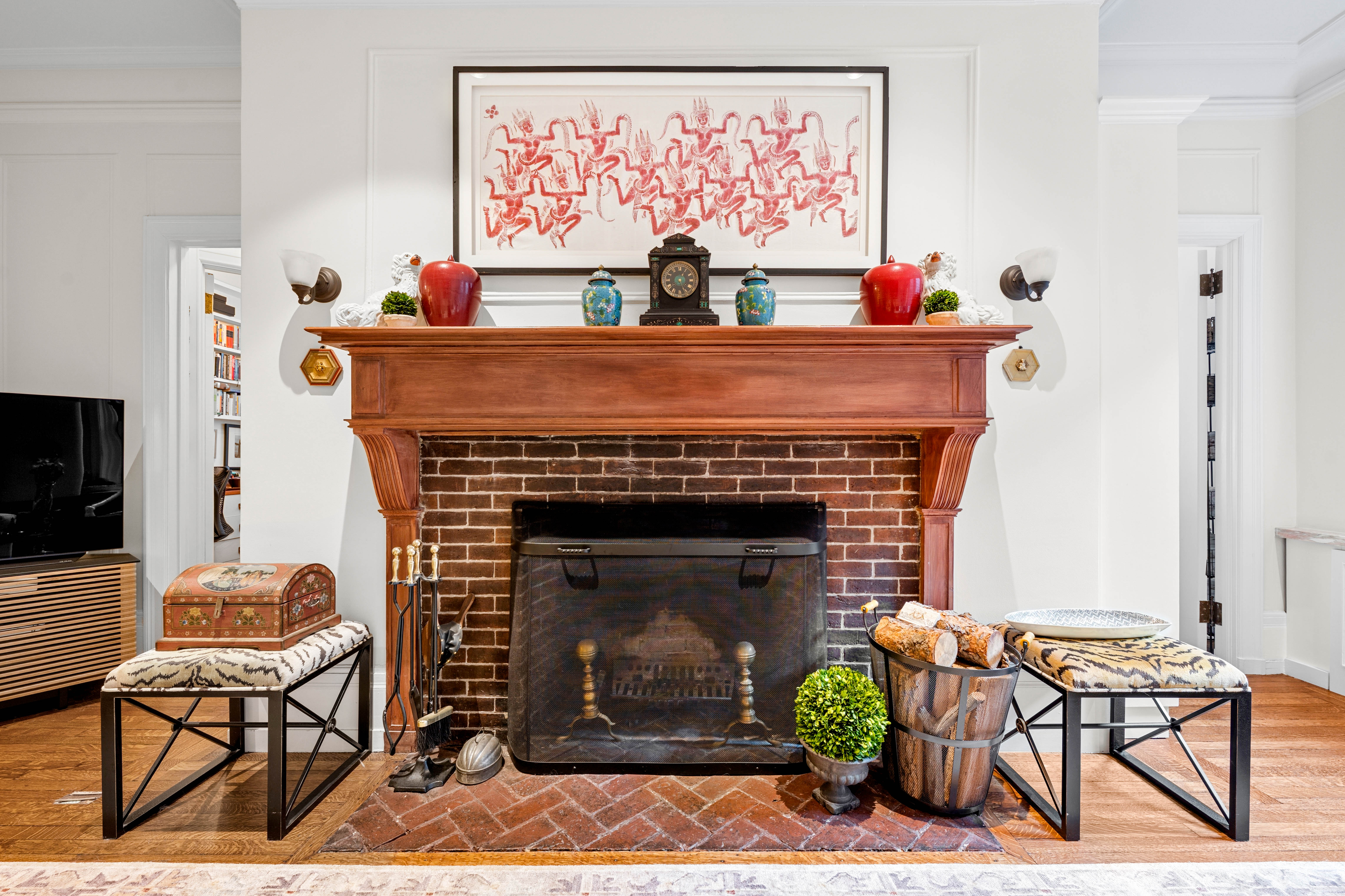 50 West 67th Street, Unit 4F Manhattan, NY 10023 - Photo 4 of 10 a living room with a fireplace and a table